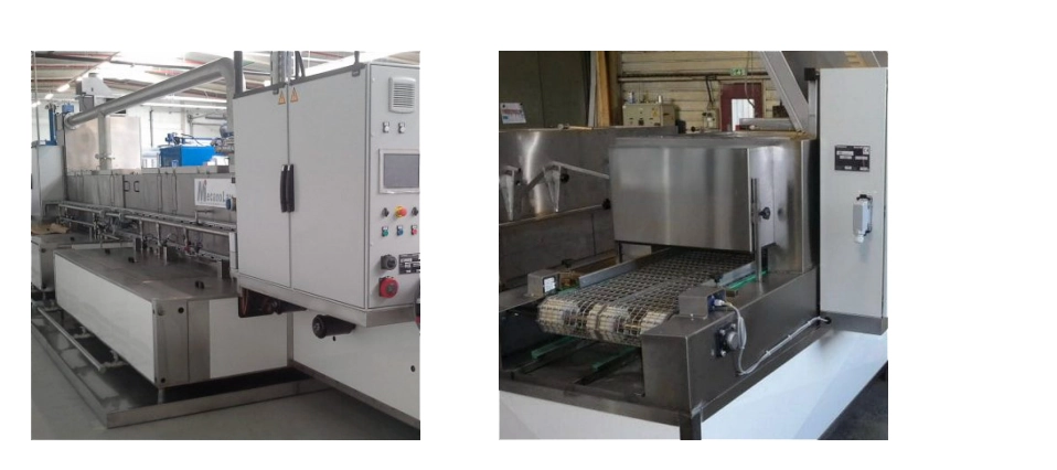 Industrial wash tunnel with a conveyor belt for the continuous cleaning of mechanical components.