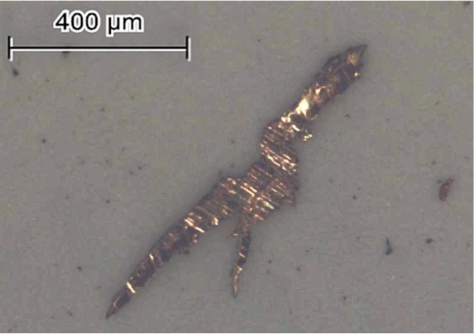 Microscopic image of a 400 µm metal particle.